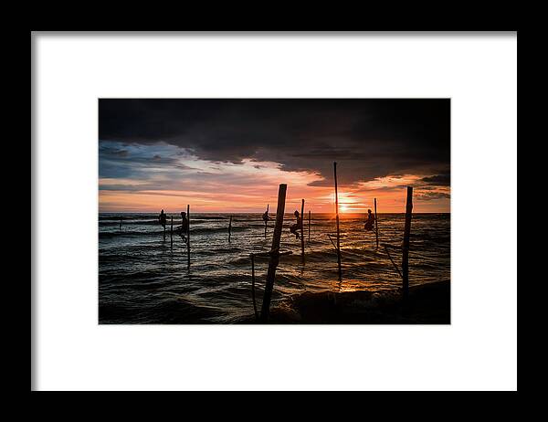 Fisherman Framed Print featuring the photograph Sunset and Stilt Fishermen by Arj Munoz