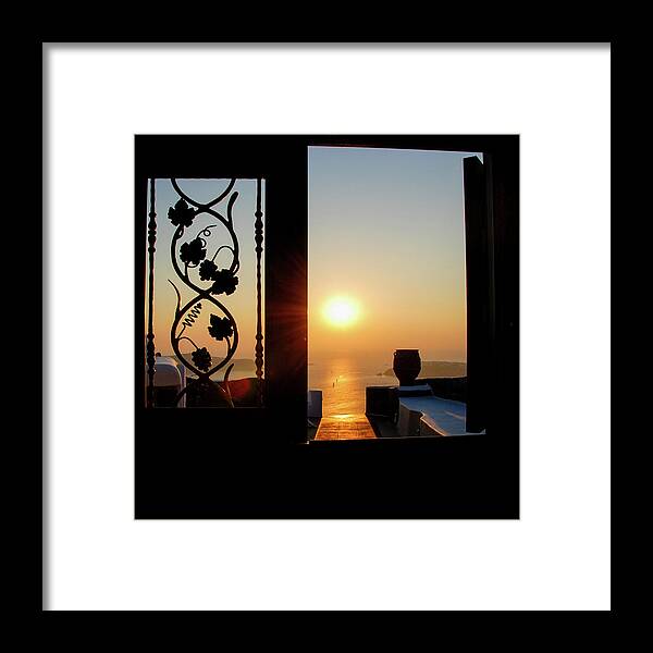 Nightfall Framed Print featuring the photograph Sunset in the aegean sea from a house. Santorini island Greece. by Michalakis Ppalis