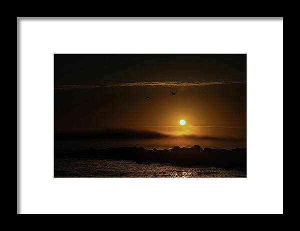 Sunset Framed Print featuring the photograph Sunset over the ocean by Micah Offman