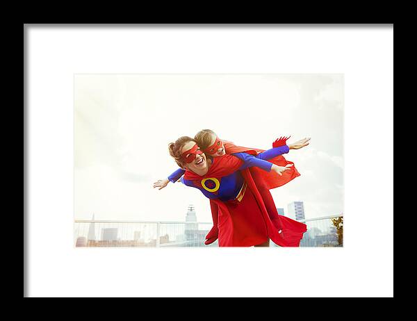 4-5 Years Framed Print featuring the photograph Superhero mother and daughter playing on city rooftop by Robert Daly
