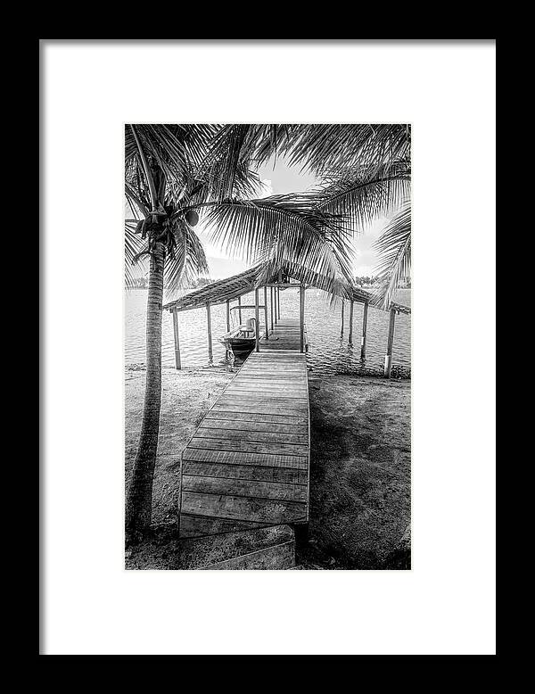 African Framed Print featuring the photograph Swaying Palms Over the Dock in Black and White by Debra and Dave Vanderlaan