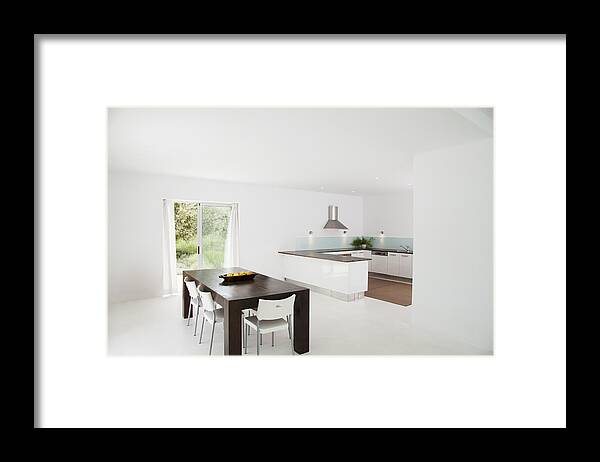 Dining Room Framed Print featuring the photograph Table and chairs in modern kitchen by Martin Barraud