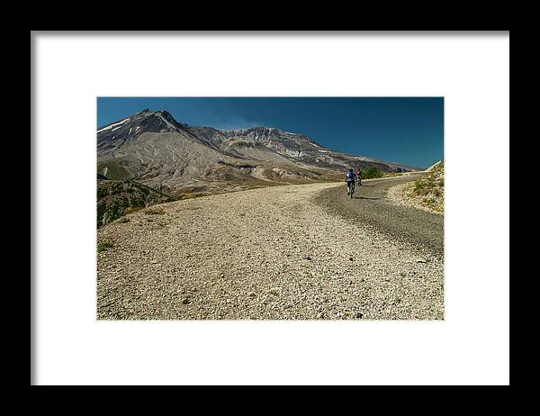Two Bicyclists On The Windy Ridge Road Pass Directly In Front Of Mt. St. Helens' Blast Zone. Framed Print featuring the photograph Take a Ride on the Wild Side by Doug Scrima