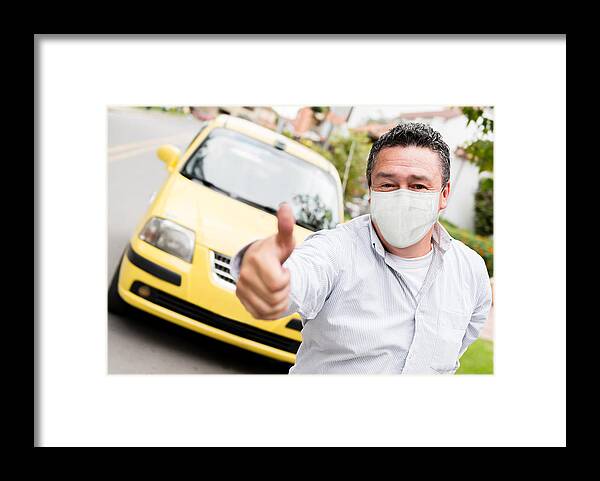 People Framed Print featuring the photograph Taxi driver with thumbs up and wearing a facemask by Andresr