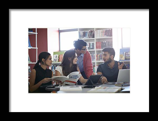 Computer Framed Print featuring the photograph Teacher assisting students, in the library by Klaus Vedfelt