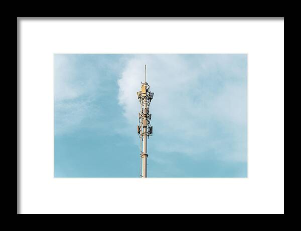 Mobile Phone Base Station Framed Print featuring the photograph Telecommunications Tower with antennas on blue sky with cloud by Liyao Xie