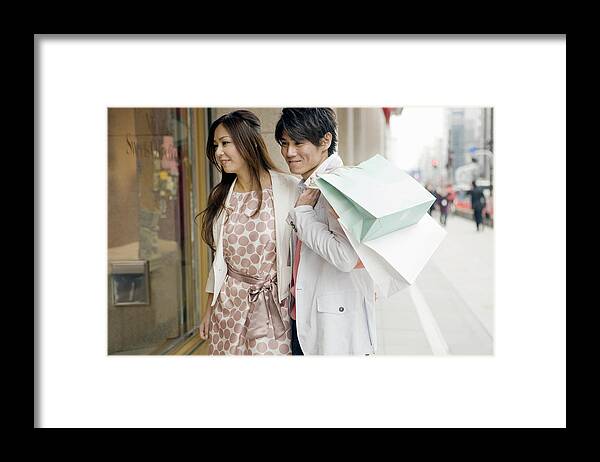 30-34 Years Framed Print featuring the photograph The man and woman is window-shopping by Michael H