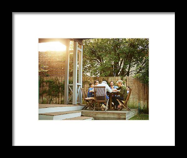 Mature Adult Framed Print featuring the photograph Three generations gathered at the table by AJ_Watt