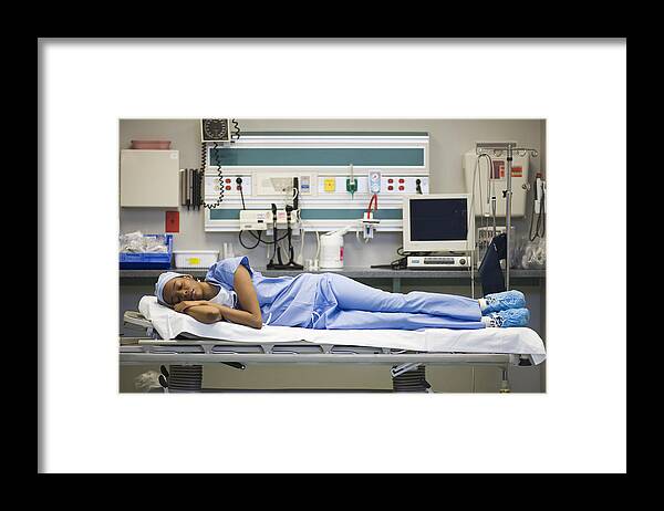 Expertise Framed Print featuring the photograph Tired black surgeon laying on hospital gurney by ER Productions Limited