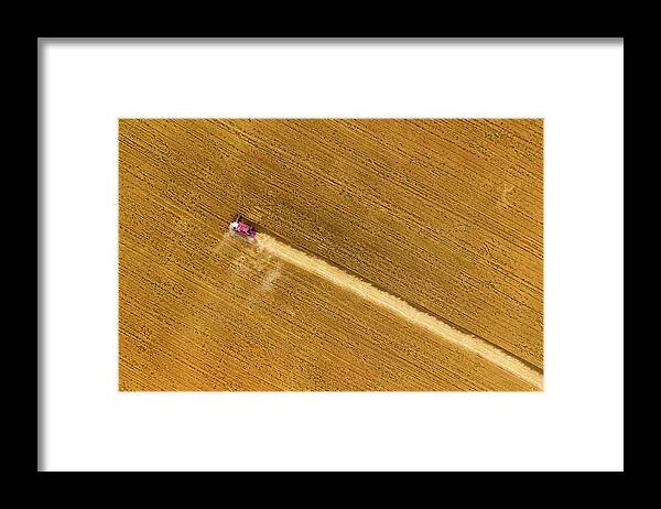 Agriculture Framed Print featuring the photograph Top view of combine on harvest field by Mikhail Kokhanchikov