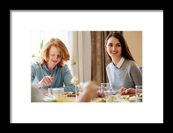 Young Men Framed Print featuring the photograph Traditional family dinner at home by CliqueImages