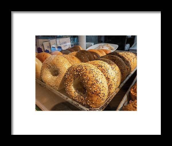 Appetizer Framed Print featuring the photograph Tray of bagels in a bakery. by Kyle Lee