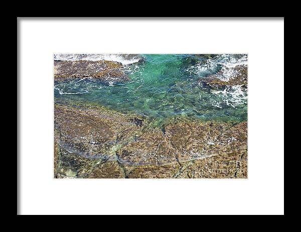 Turquoise Framed Print featuring the photograph Turquoise Blue Water And Rocks On The Coast by Adriana Mueller