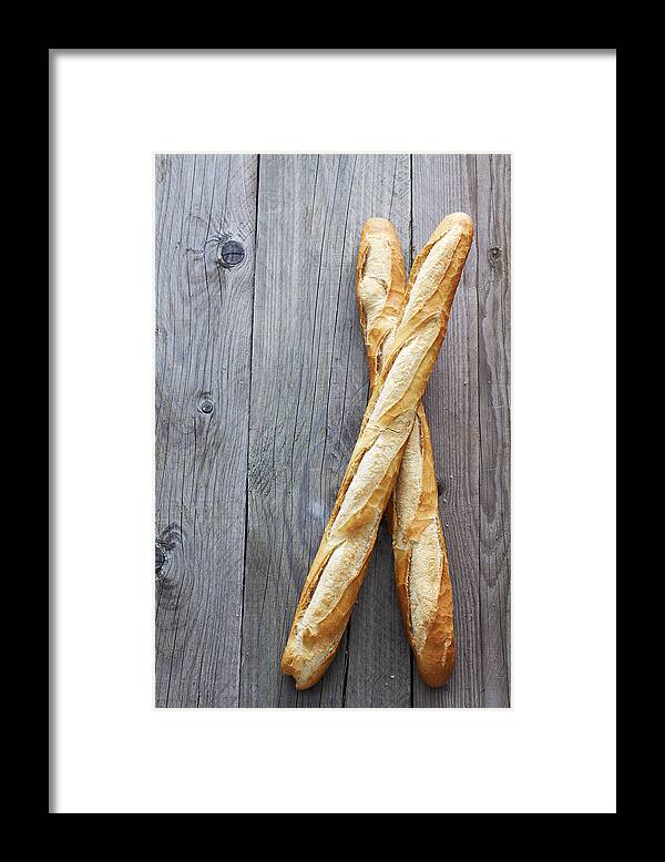 Baguette Framed Print featuring the photograph Two French baguettes on grey wood by Westend61