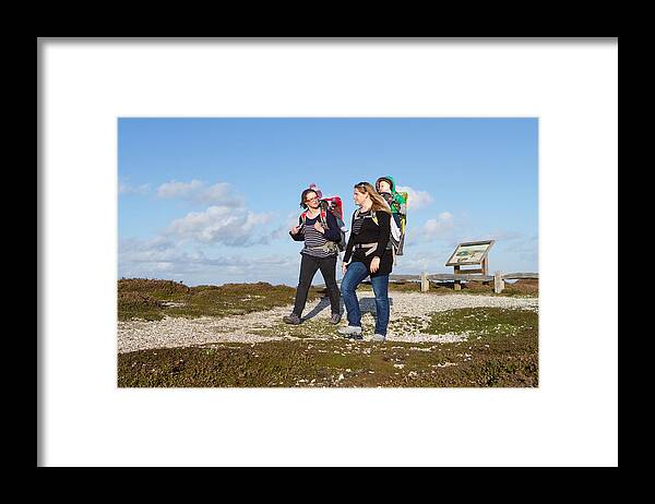 Mid Adult Women Framed Print featuring the photograph Two mother and baby walking on coastal by s0ulsurfing - Jason Swain