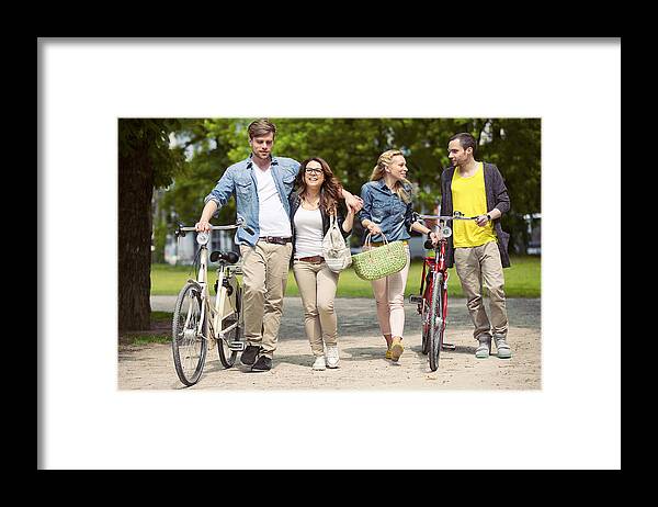 Young Men Framed Print featuring the photograph Two Teenage Couples With Bikes by Efenzi