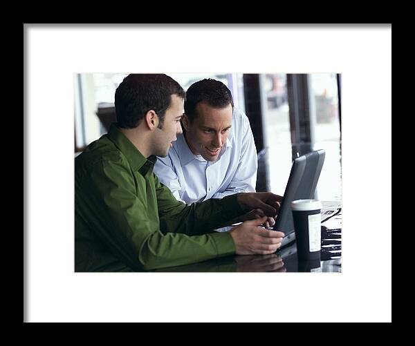 White People Framed Print featuring the photograph Two Young Caucasian Men Look At A Computer And Converse About Its Content by Photodisc