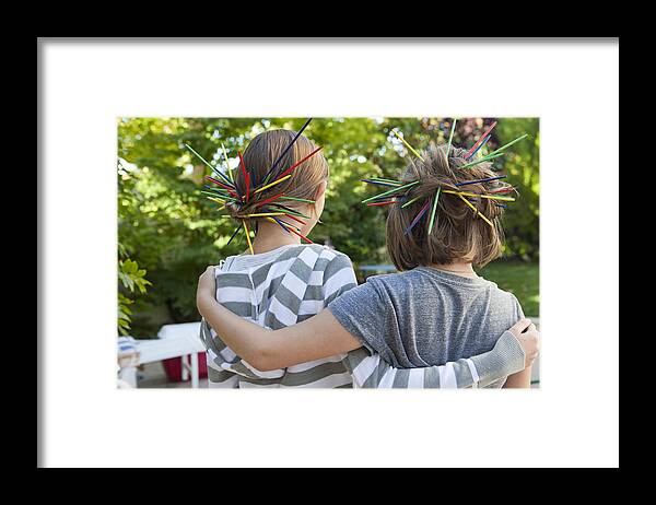 Outdoors Framed Print featuring the photograph Two young girls embracing each other by Geri Lavrov