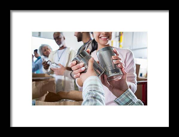 Working Framed Print featuring the photograph Unrecognizable person donates food during food drive by SDI Productions