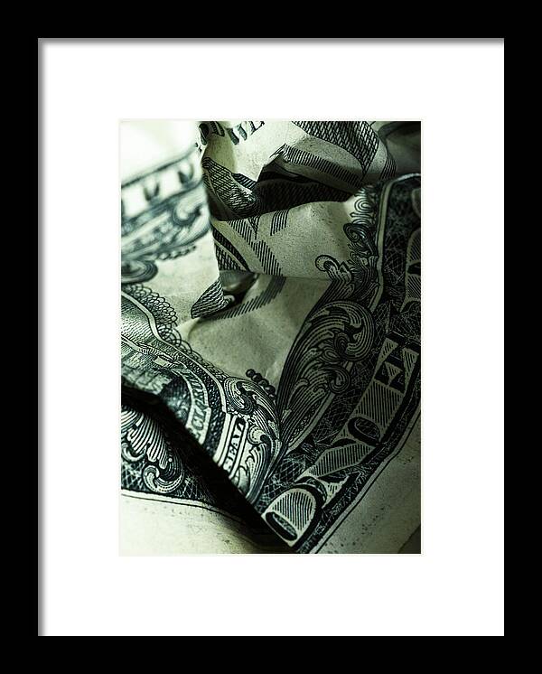 Single Object Framed Print featuring the photograph US currency: crumpled one dollar bill, close-up by Microzoa