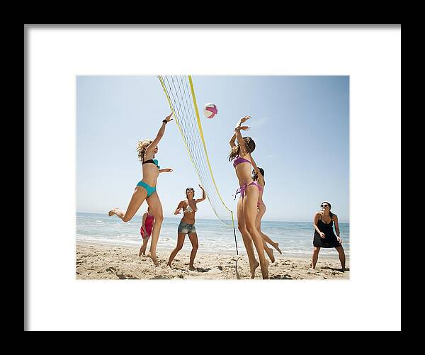 People Framed Print featuring the photograph USA, California, Malibu, Group of young women playing beach volleyball by Tetra Images - Erik Isakson