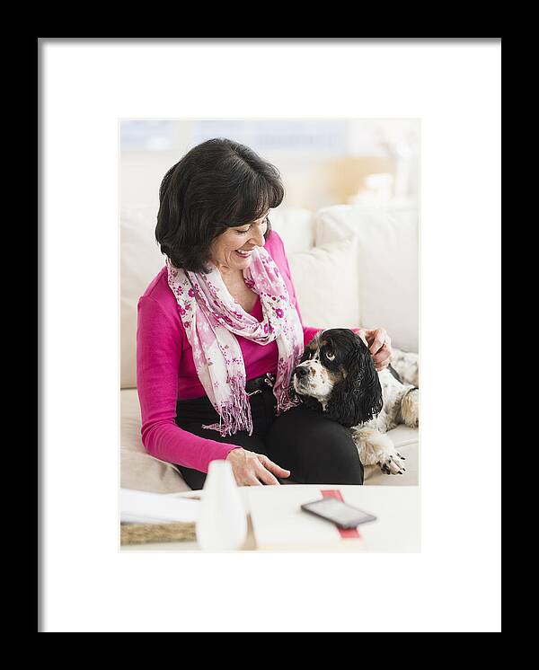 Pets Framed Print featuring the photograph USA, New Jersey, Jersey City, Portrait of senior woman sitting on sofa with her dog by Tetra Images