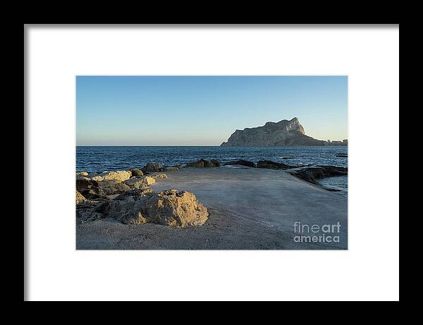 Mediterranean Coast Framed Print featuring the photograph Warm evening light meets deep blue by Adriana Mueller
