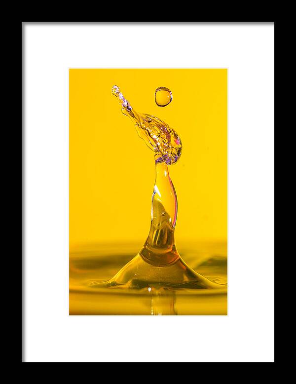 Art Framed Print featuring the photograph Water drip on a yellow backdrop by Robbie Goodall