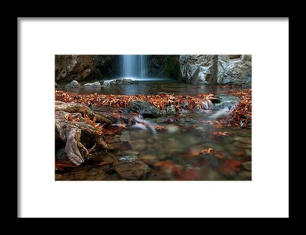 Troodos Framed Print featuring the photograph Waterfall and river flowing with maple leaves on the rocks on the river in Autumn by Michalakis Ppalis
