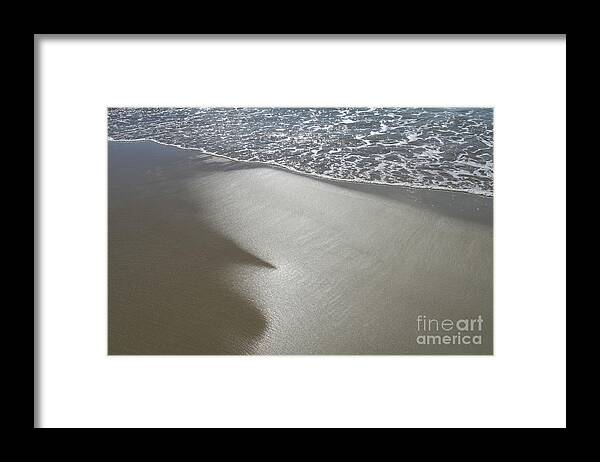 Sandy Beach Framed Print featuring the photograph Wet sand, sea water and reflections of sunlight by Adriana Mueller
