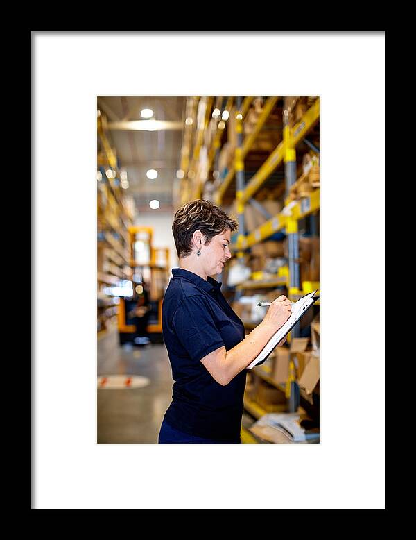 Working Framed Print featuring the photograph Woman checking packages by Zoranm