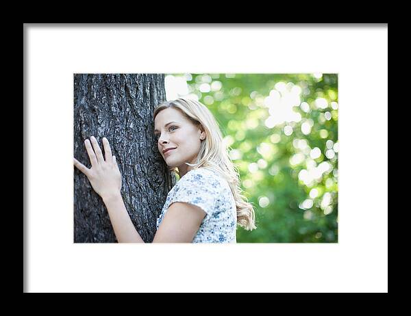 Beautiful Woman Framed Print featuring the photograph Woman hugging tree outdoors by Tom Merton