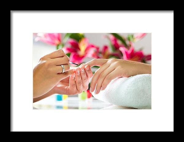 Flower Framed Print featuring the photograph Woman in a nail salon receiving a manicure by Kzenon