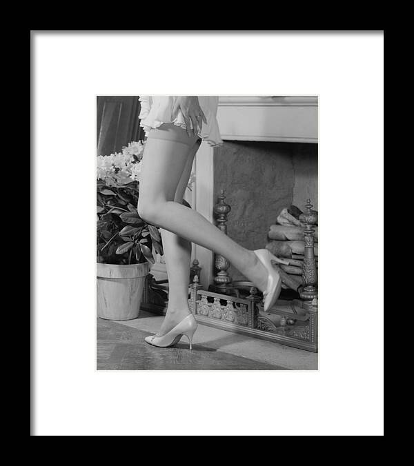 People Framed Print featuring the photograph Woman in mini skirt and high heels dancing by fireplace, low section by George Marks