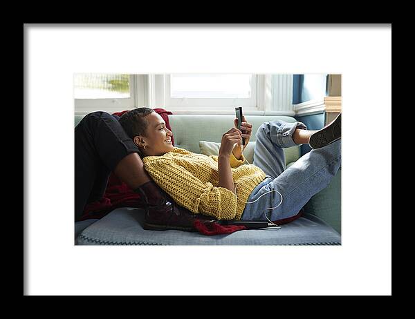 Internet Framed Print featuring the photograph Woman messaging on phone while leaning on friend by Klaus Vedfelt