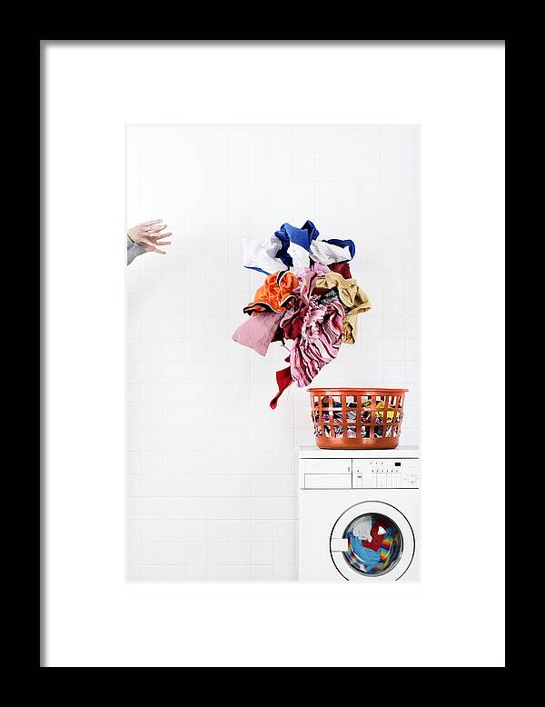 White People Framed Print featuring the photograph Woman throwing pile of laundry to basket on washing machine by Martin Poole
