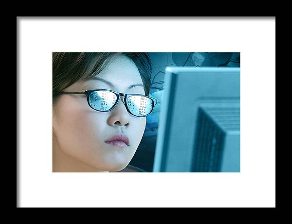 Corporate Business Framed Print featuring the photograph Woman with a reflection off a computer in her glasses by Comstock Images