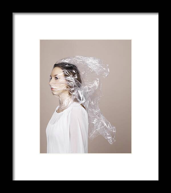 30-34 Years Framed Print featuring the photograph Woman wrapped in plastic by Henrik Sorensen