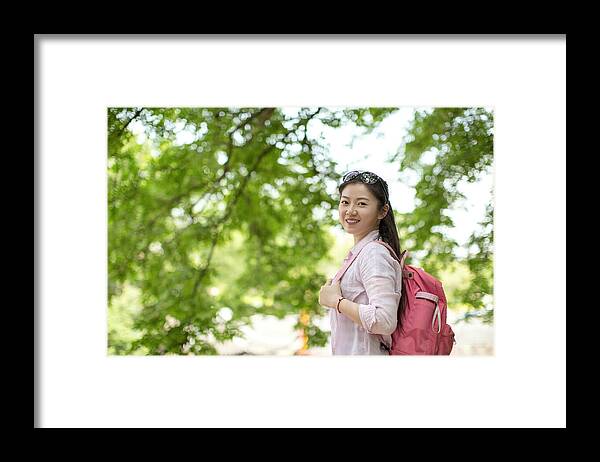 Expertise Framed Print featuring the photograph Young asian woman under tree,smiling and looking to camera by Xia Yuan
