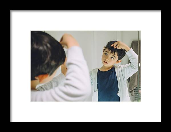 Asian And Indian Ethnicities Framed Print featuring the photograph Young boy getting ready to go out. by © Peter Lourenco