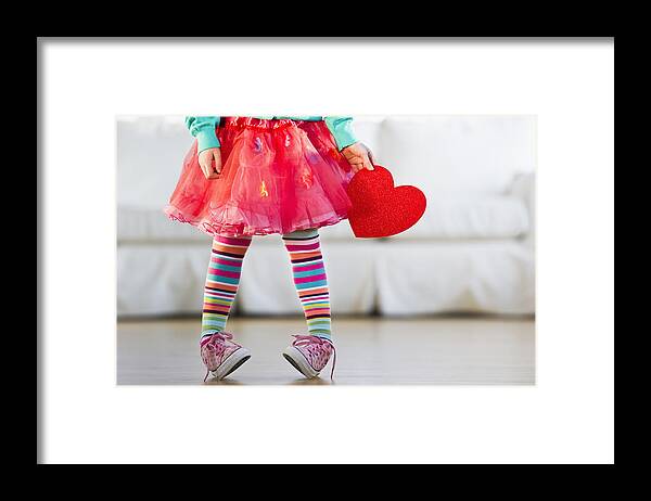 Child Framed Print featuring the photograph Young girl wearing colorful tights by Tetra Images - Daniel Grill