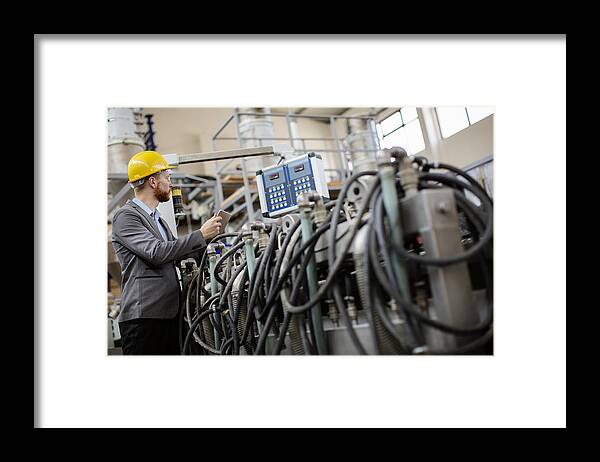 Expertise Framed Print featuring the photograph Young male inspector in factory by Milanvirijevic