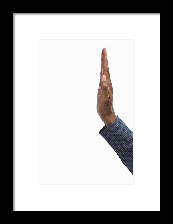White Background Framed Print featuring the photograph Young man making stop gesture, side view, close-up of hand by Thomas Northcut