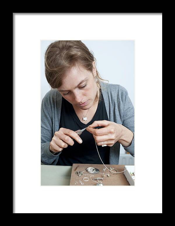 People Framed Print featuring the photograph Young woman makes a necklace by Reza Estakhrian