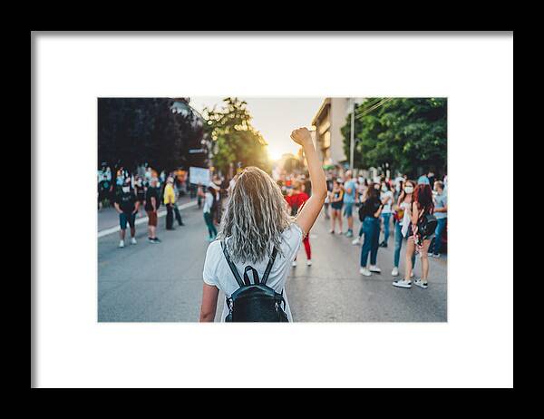 Democracy Framed Print featuring the photograph Young woman protester raising her fist up by LordHenriVoton