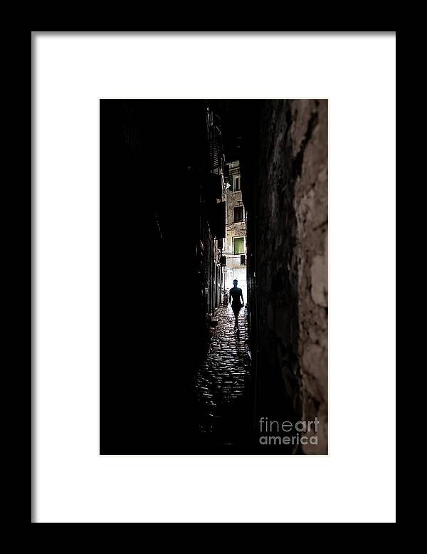  Framed Print featuring the photograph Young Woman Walks Alone Through Spooky Narrow Abandoned Alley In The Night by Andreas Berthold