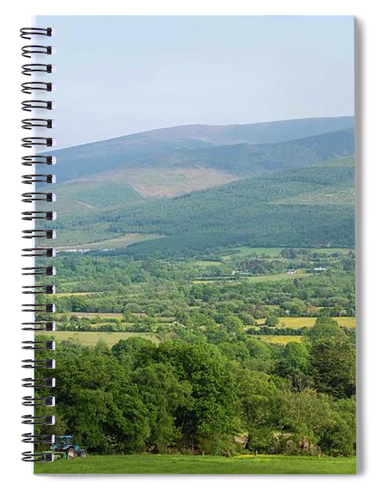 Working Spiral Notebook featuring the photograph A Farmer In His Tractor Working The by Leverstock