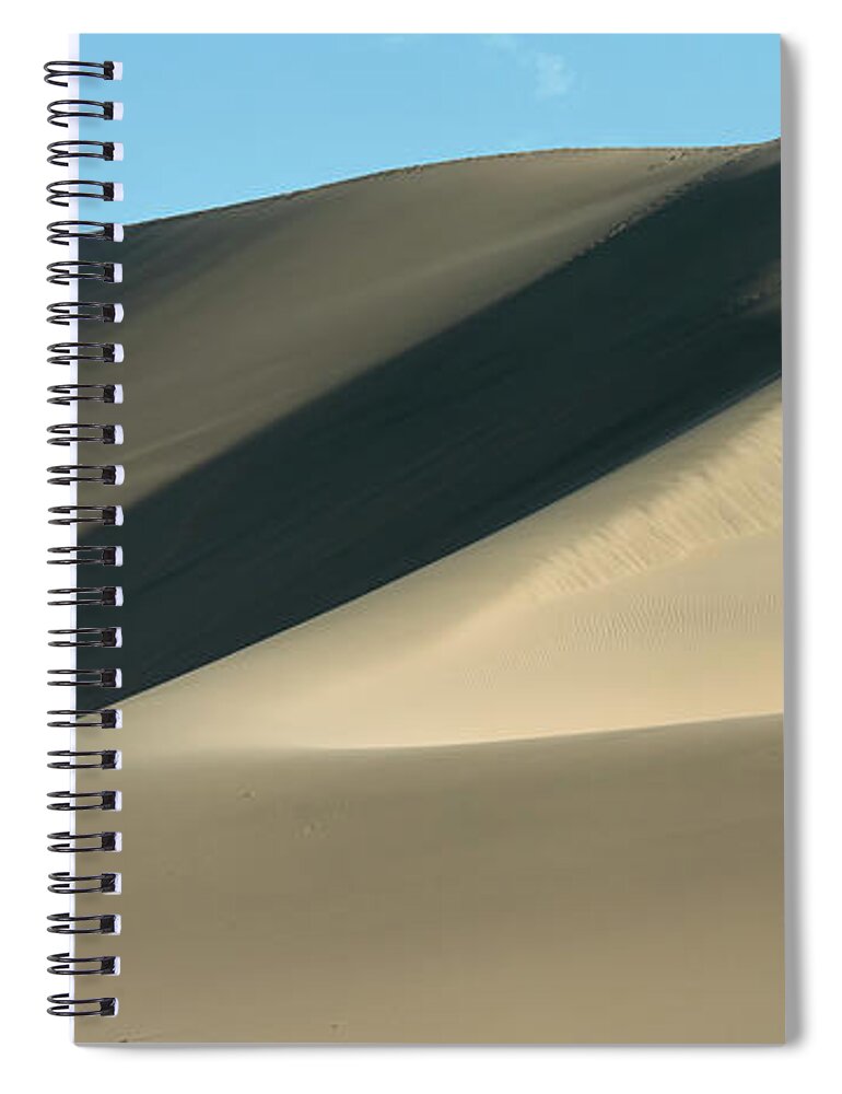 Shadow Spiral Notebook featuring the photograph A Large Sand Dune Against A Blue Sky by Keith Levit / Design Pics