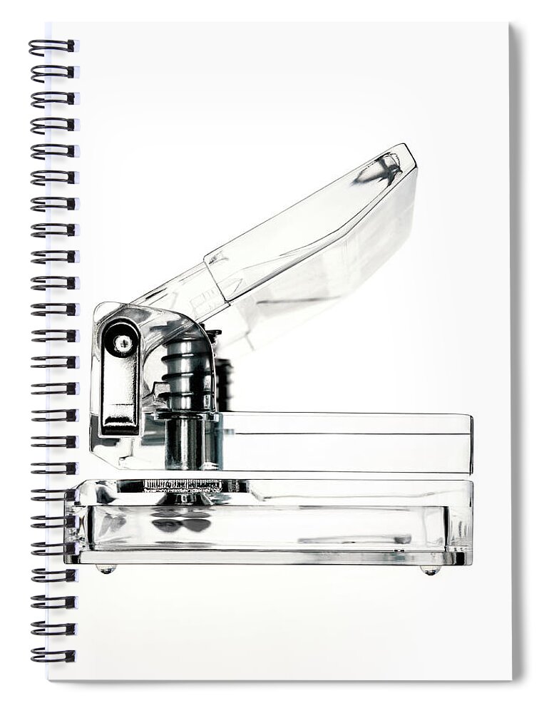 Clear Hole Puncher On A White Background Spiral Notebook by Peter Dazeley 