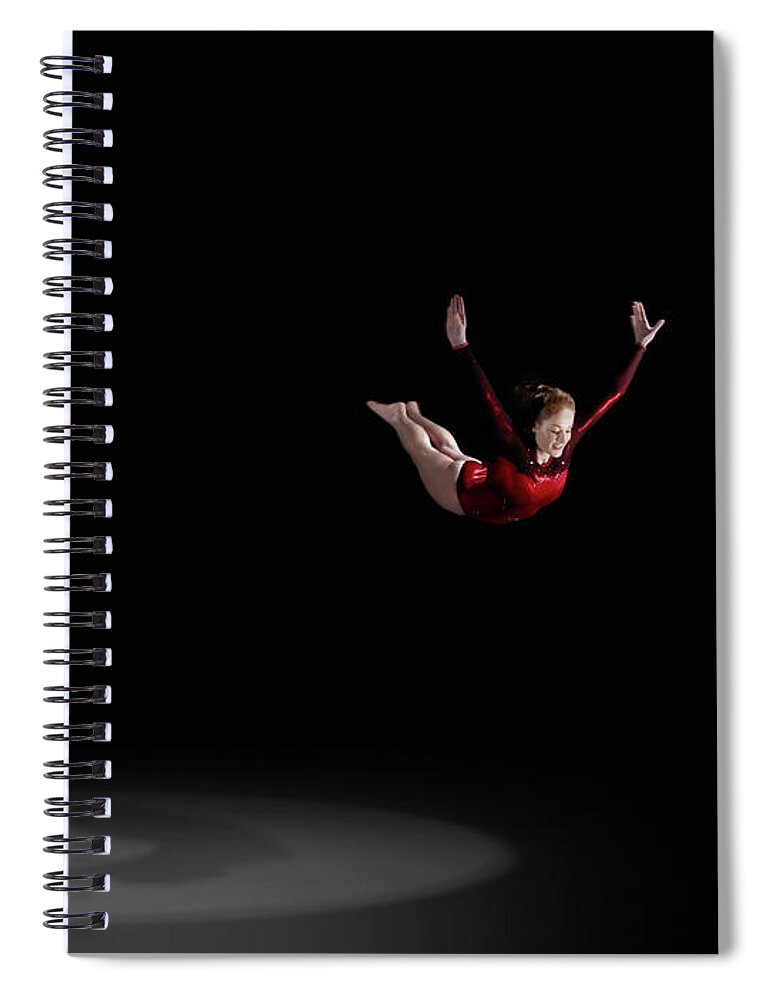 Focus Spiral Notebook featuring the photograph Female Gymnast Soaring Through Air by Mike Harrington